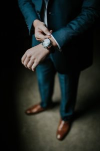 man holding his black suit confident man